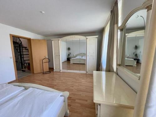 a bedroom with a bed and a large mirror at Haus in Ossendorf Köln in Cologne