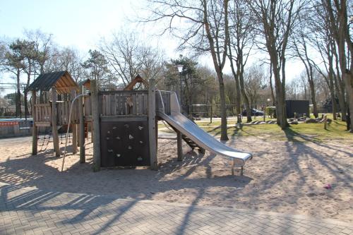 a playground with a slide in a park at Vakantiewoning Kijkduinpark in The Hague
