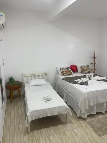 two beds sitting next to each other in a room at Villa Brilho do Sol Jeri in Jericoacoara