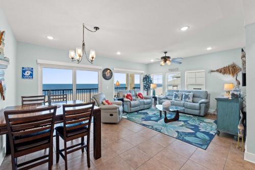 a dining room and living room with a table and chairs at The Vue by Panhandle Getaways in Mexico Beach