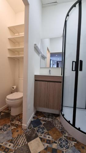 une salle de bain avec toilettes et douche en verre dans l'établissement Studio Machy - Centre-Ville et Parking Gratuit, à Bourbourg