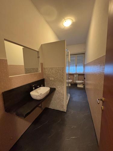 a bathroom with a sink and a mirror at Marconi Rooms and Apartments in Verona