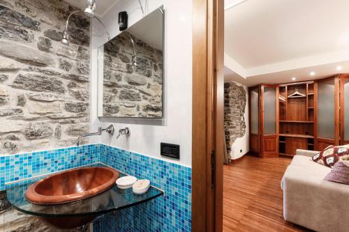 a bathroom with a wooden tub on a tile wall at Crotto Polirolo by "The House Of Travelers" in Cernobbio
