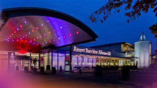 a shopping center with a building with purple lights at Avalon II in Thannenkirch