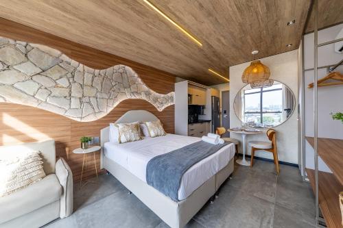 a bedroom with a large white bed and a table at New Time 715 - Luxo à beira-mar da Pajuçara in Maceió
