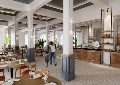 een vrouw en een kind die door een restaurant lopen bij Diamonds Bijoux in Bwejuu