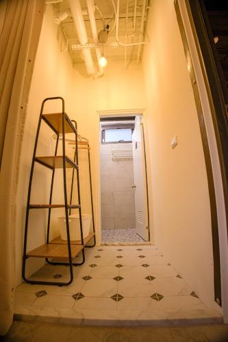 a hallway with a tiled floor and a ladder at 小島月光民宿 Moonlit Isle in Green Island