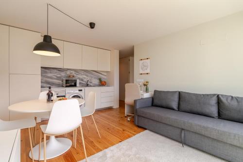a living room with a couch and a table at HostWise – Modern & Cozy Flat | Near the Beach in Matosinhos