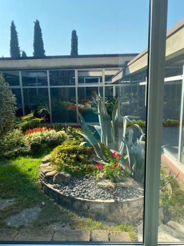 a window view of a garden outside a building at Claudia-Al Vittoriale in Gardone Riviera