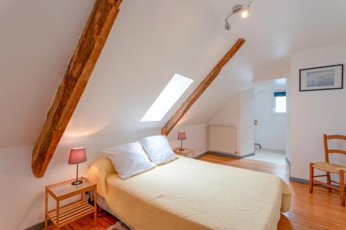 - une chambre avec un lit dans une pièce dotée de poutres dans l'établissement Gite Tété près de Lourdes, à Artigues
