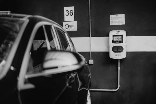 a car is parked next to a parking meter at Residenza Dell' Opera in Turin