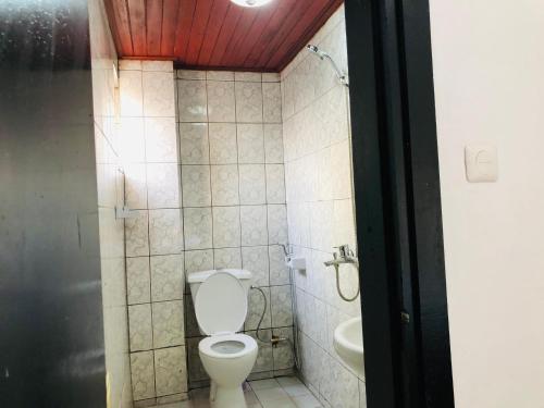 a bathroom with a toilet and a sink at BSA Douala in Douala