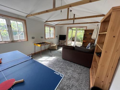 a living room with a ping pong table in it at Gwydyr House in Ryde