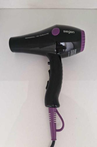 a black and purple hair dryer hanging on a wall at Espectacular vista y ubicación in Santiago