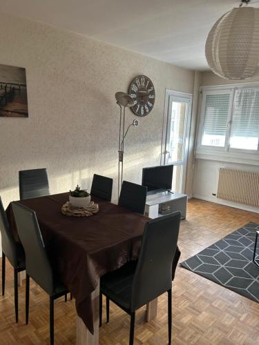 une salle à manger avec une table et des chaises dans l'établissement appartement proche centre ville quartier laennec, à Chalon-sur-Saône
