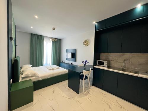 a bedroom with a bed and a sink and a tub at EKAM Sun Apartments in Golem