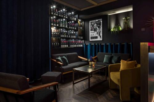 a bar with two couches and a table at Hotel ZOE by AMANO in Berlin