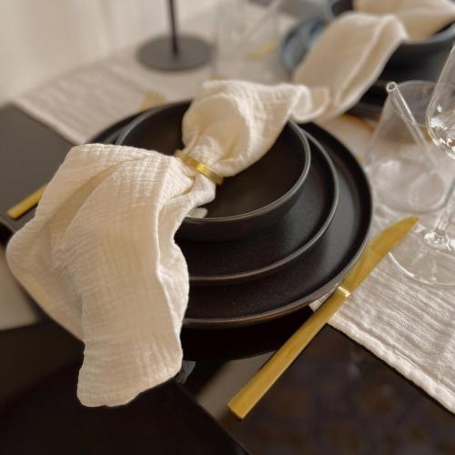 a table with a black plate with a napkin on it at Apartment in zentraler Lage in Bad Neustadt an der Saale