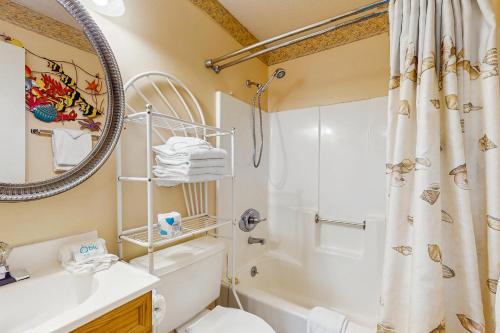 a bathroom with a shower and a toilet and a sink at Beach Front #203 in Gulf Shores