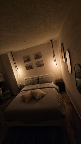 a bedroom with a large bed with lights on it at Isula SeaView Apartments in Isola delle Femmine