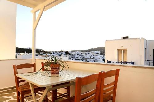 a table and chairs on a balcony with a view at Rodis Cycladic Holiday House in Naousa