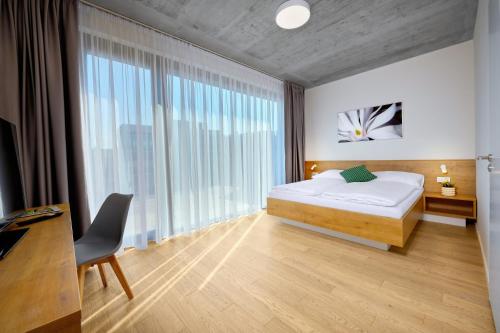 Кровать или кровати в номере DownTown Suites Andel