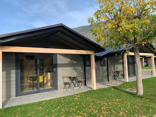 a house with a patio with a table and chairs at Càmping Organyà Park in Organyà