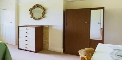a bedroom with a dresser and a mirror on the wall at JosepTalaia Villa Top-Class-Villa-Ibiza in Sant Josep