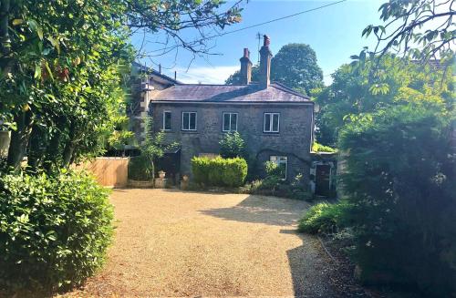 an old stone house with a yard in front of it at Gwydyr House in Ryde