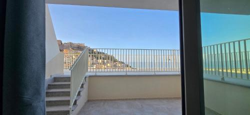 a balcony with stairs and a view of the ocean at Residenza Albachiara in Castelsardo