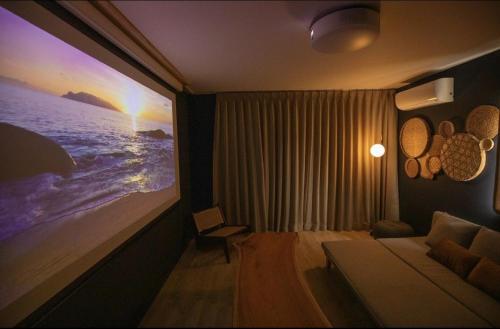 a living room with a large painting on the wall at 興津ビーチサイドヴィラ 勝浦 - Okitsu Beachside Villa - Katsuura in Katsuura