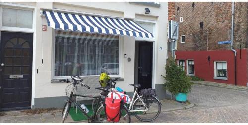 two bikes parked in front of a building at Thorbecke Canal View 42 m2 Loft in Zwolle