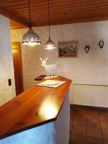 a kitchen counter with a statue of a deer on it at Wamperling - Erlebnisbrauerei mit wildem Wirtshaus und Pension in Neustadt bei Coburg