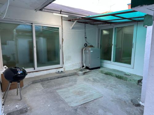 a room with a heater and some windows at Hanok House with a Yard 1 in Seoul