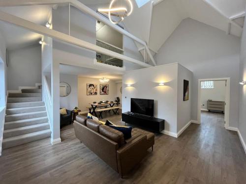 a living room with a couch and a fireplace at A Cozy Magical Retreat at Knightwood Oak, New Forest in Ower