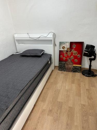 a bedroom with a bed and a wooden floor at Hanok House with a Yard 1 in Seoul