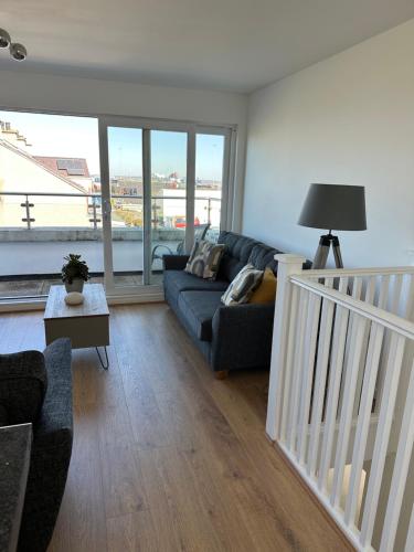 a living room with a couch and a table at Quayside in Holyhead