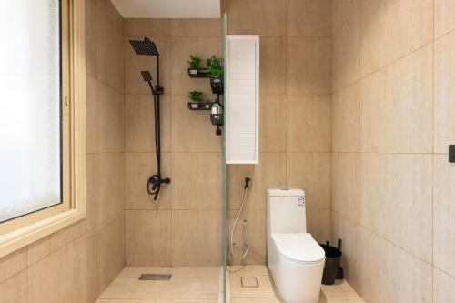 a bathroom with a shower and a toilet in it at بيتك - Baytak in Al Madinah