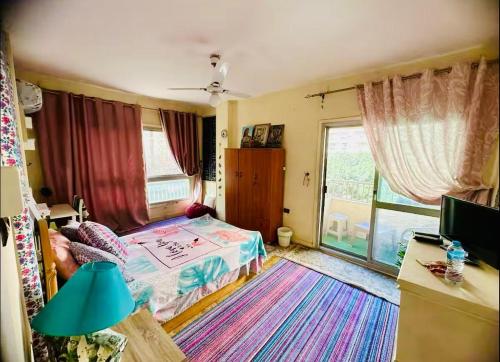 a bedroom with a bed and a large window at BlueHostel in Cairo