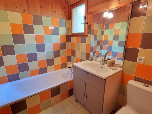 a bathroom with a sink and a tub and a toilet at Chalet avec SPA, 6 Couchages, Terrasse Sud & Confort à Saint-Michel-de-Chaillol - FR-1-393-7 in Saint-Michel-de-Chaillol