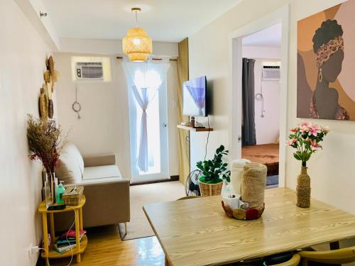 a living room with a table and a room with a couch at The Boho Bungalow in Sasabayou