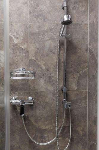 a shower in a bathroom with a glass wall at Nordian Classic in Kyiv in Kyiv