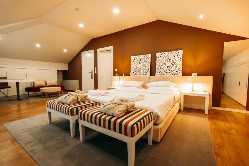 a large bedroom with two beds and a desk at Borralha Hotel, Restaurante & Spa in Vila Real