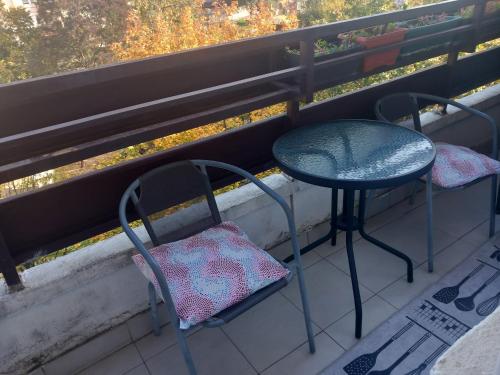 a table and two chairs sitting on a balcony at Djordje in Belgrade