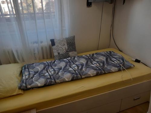 a small bed in a room with a window at Djordje in Belgrade