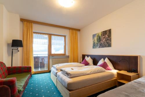 Postel nebo postele na pokoji v ubytování Hotel Martellerhof