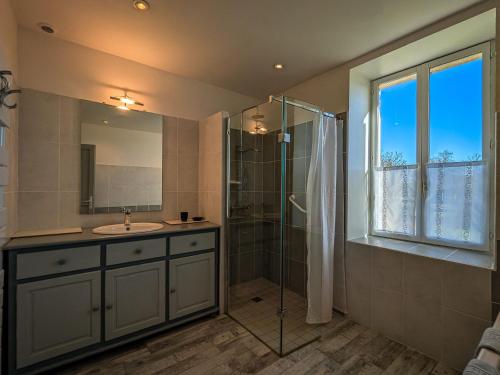 a bathroom with a sink and a shower at Gîte en Brenne avec Terrasse et Garage Privé - FR-1-591-316 in Migné