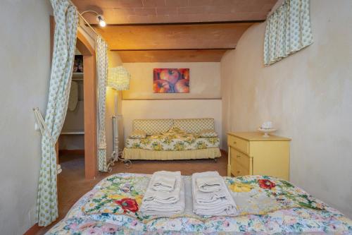 a bedroom with a bed and a dresser in it at San Giovanni Residence in Peccioli
