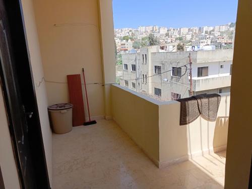 a room with a window with a view of a city at Elegant Room in Prime Location Close to Airport in Amman