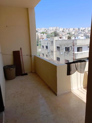 an empty room with a view of a building at Elegant Room in Prime Location Close to Airport in Amman